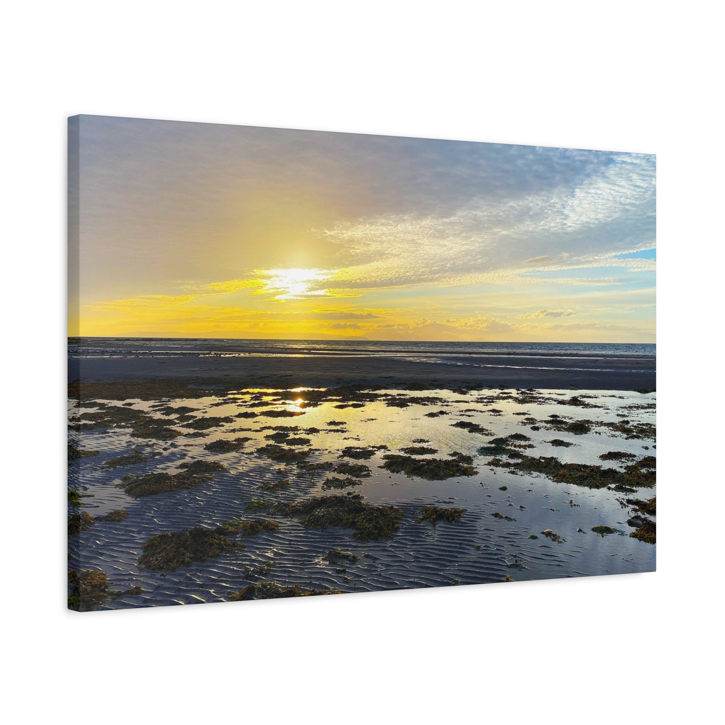 Canvas print of a sunset over a beach with water and sky.