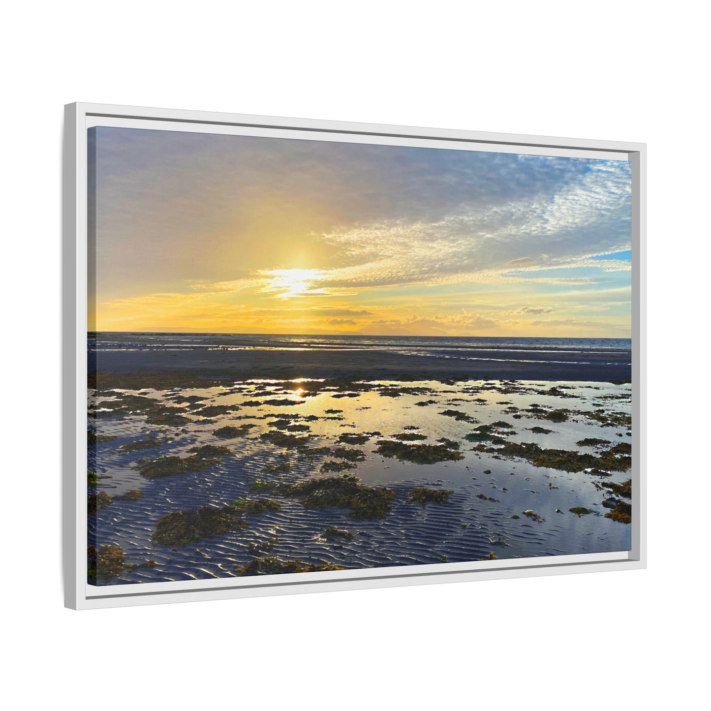 Framed artwork of a sunset over water with a white frame.