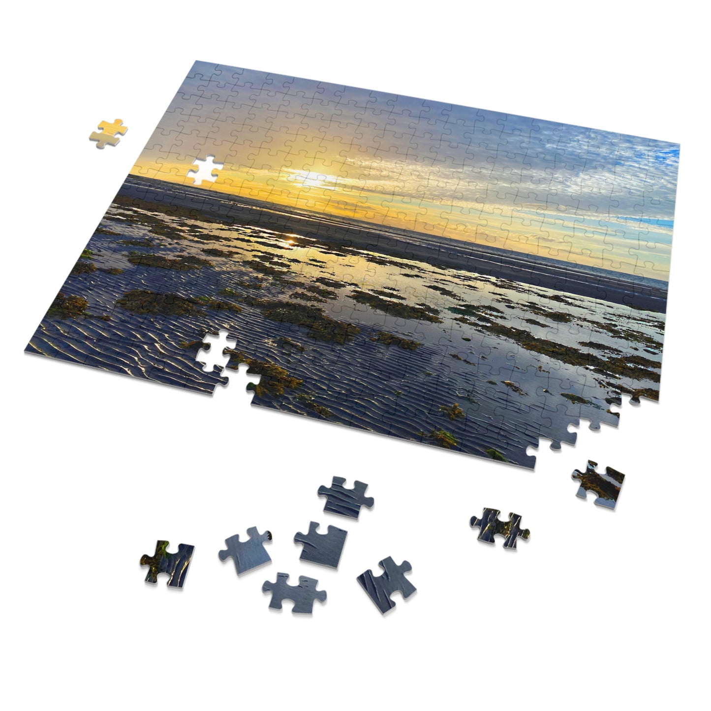 Jigsaw puzzle with a sunset over water scene, some pieces missing.