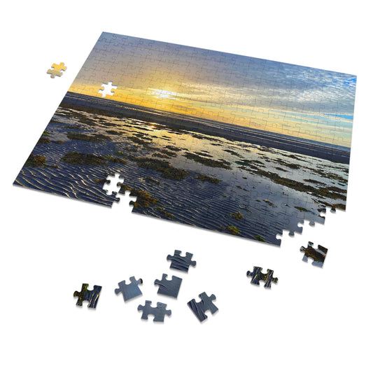Jigsaw puzzle with a sunset over water scene, some pieces missing.