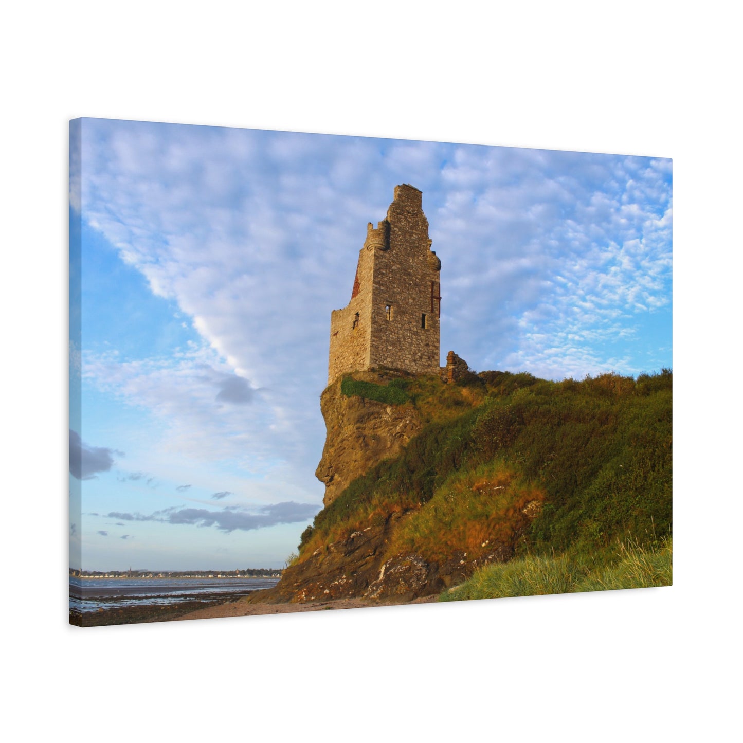 Ruins of a tower on a cliff with a blue sky and clouds