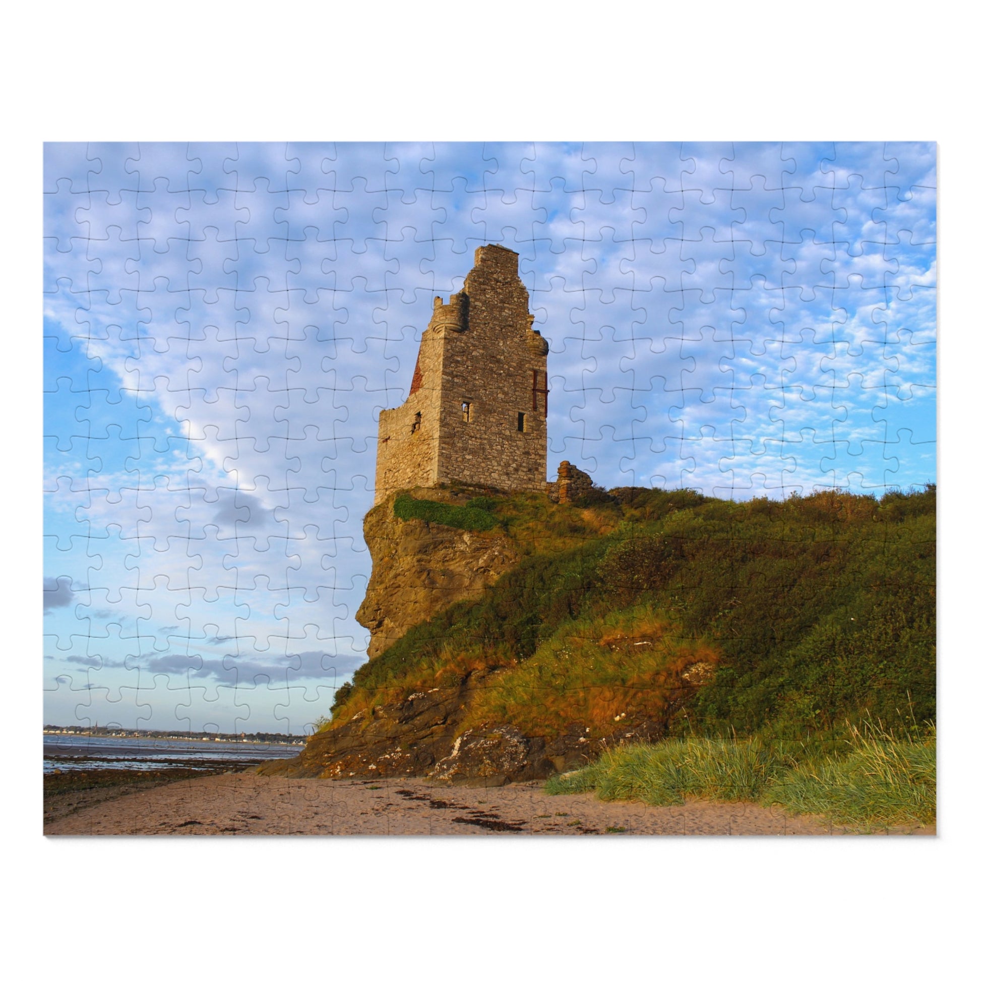 Ruins of a tower on a cliff with a blue sky and clouds