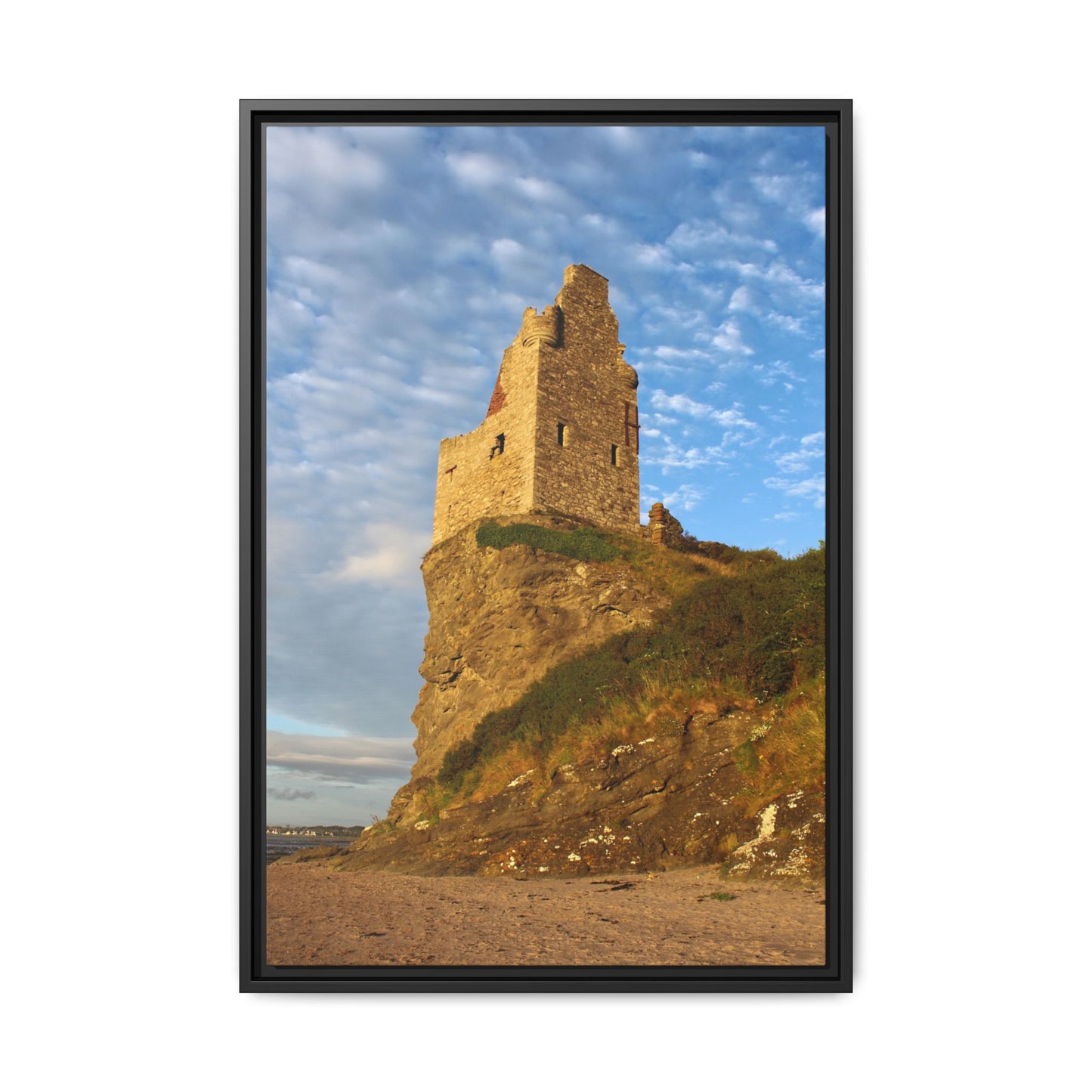 Framed photograph of a castle ruin on a cliff with a blue sky.