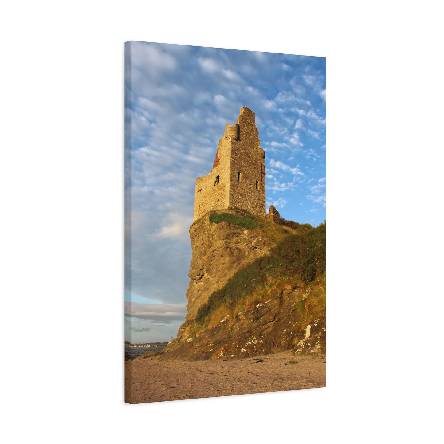 Castle ruins on a cliff with a blue sky and clouds