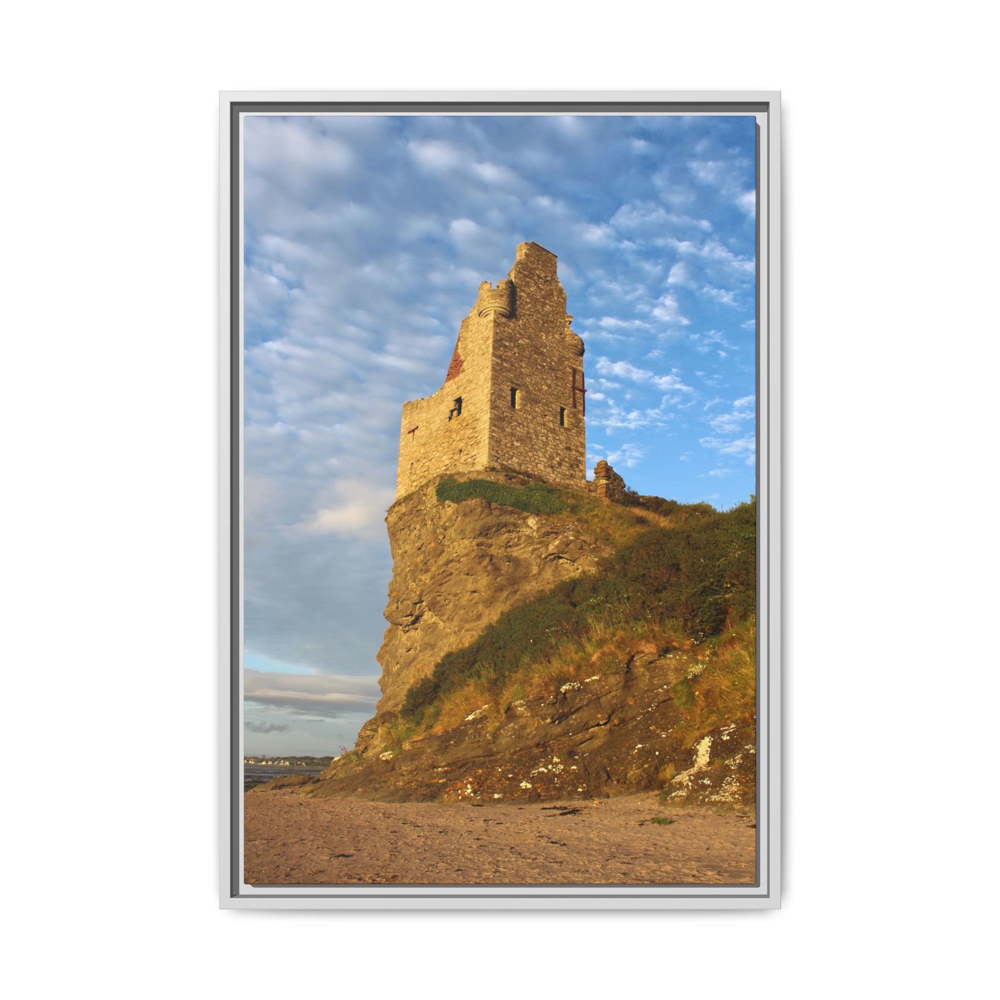 Framed photograph of a castle ruin on a cliff with a blue sky.