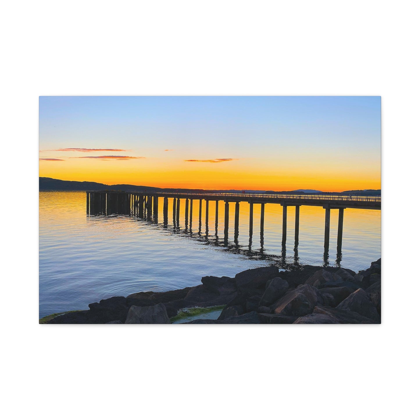 Sunset over a dock reflected in water with a white border