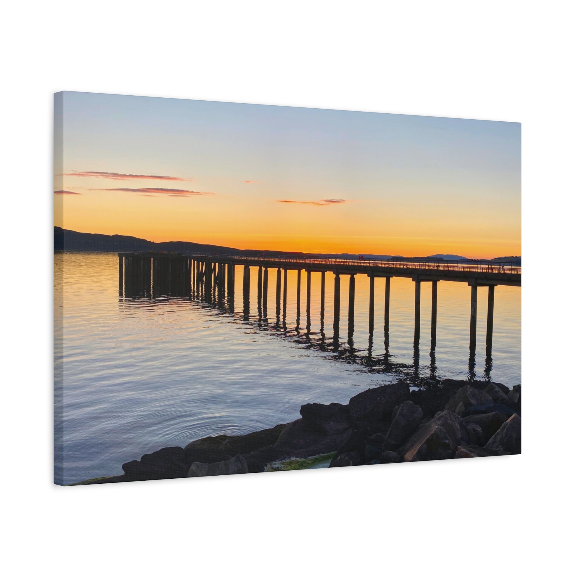 Canvas print of a sunset over a dock with a calm lake