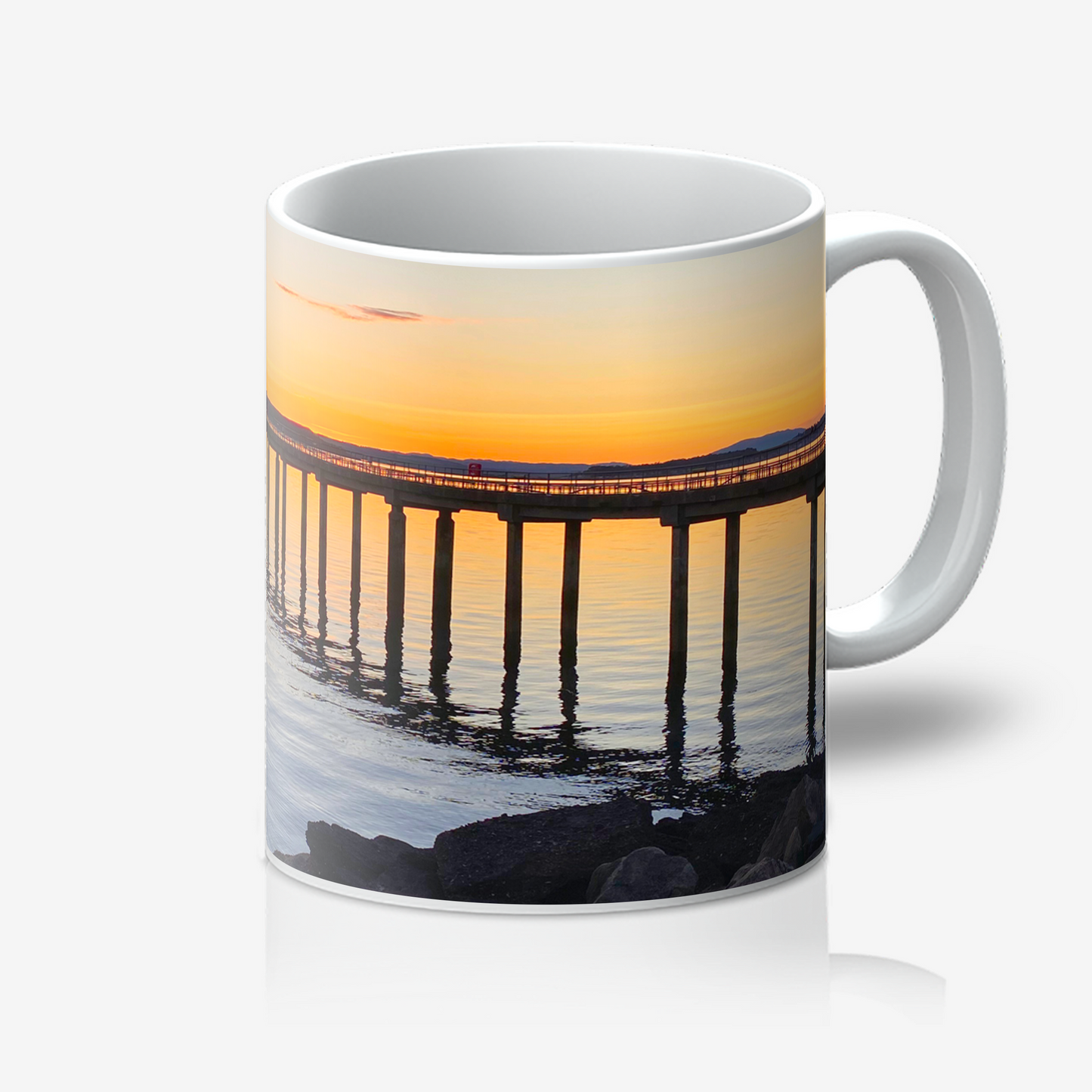 Mug with a sunset over a pier design on a white background