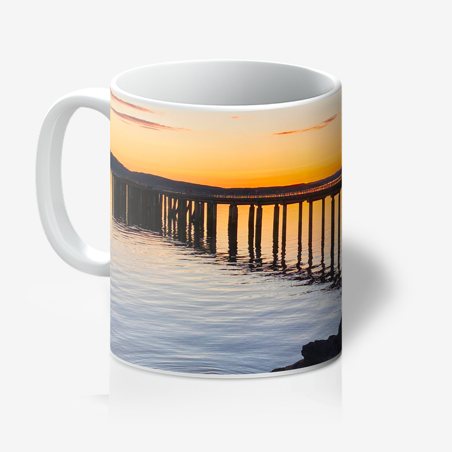 Mug with a sunset over water and pier design on a white background