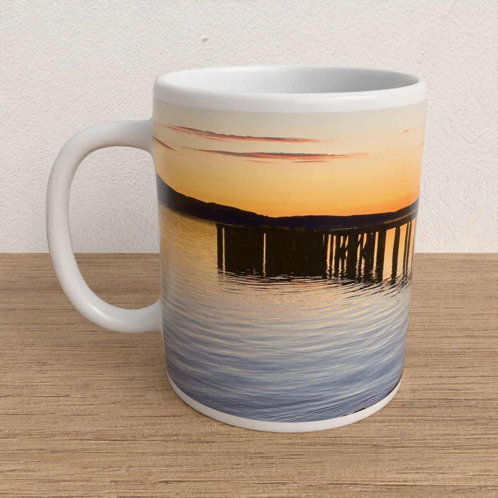 Mug with sunset design on a wooden surface