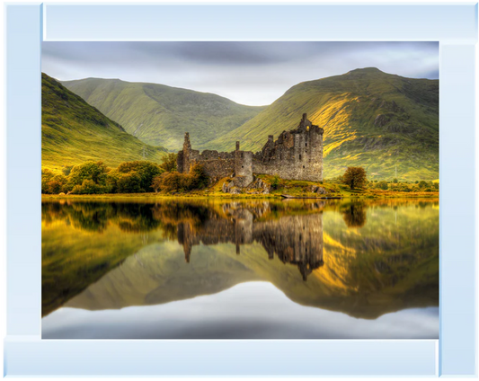 Mirror framed wall art with a castle reflected in a lake with mountains in the background.