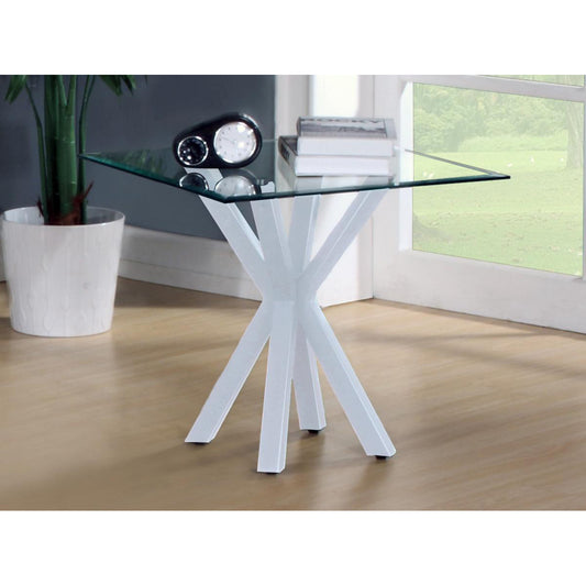 A white high gloss lamp table with a glass top, featuring a simple, modern design. The table is positioned in a bright room next to a window, with a black lamp and a book on top.