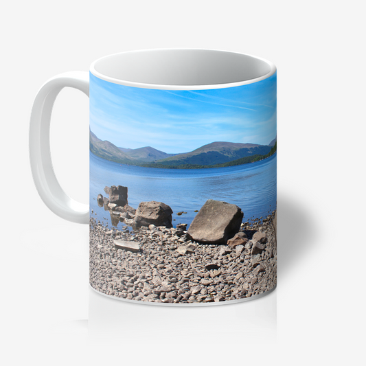 Mug with a scenic design of a lake and mountains on a white background