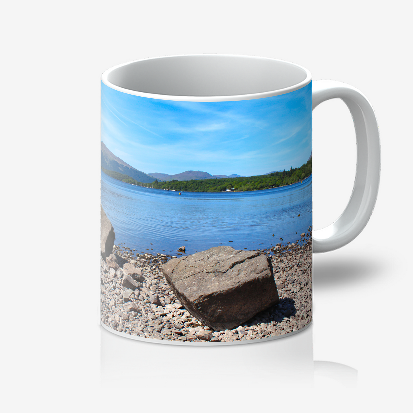 Mug with a scenic design of a lake and mountains on a white background