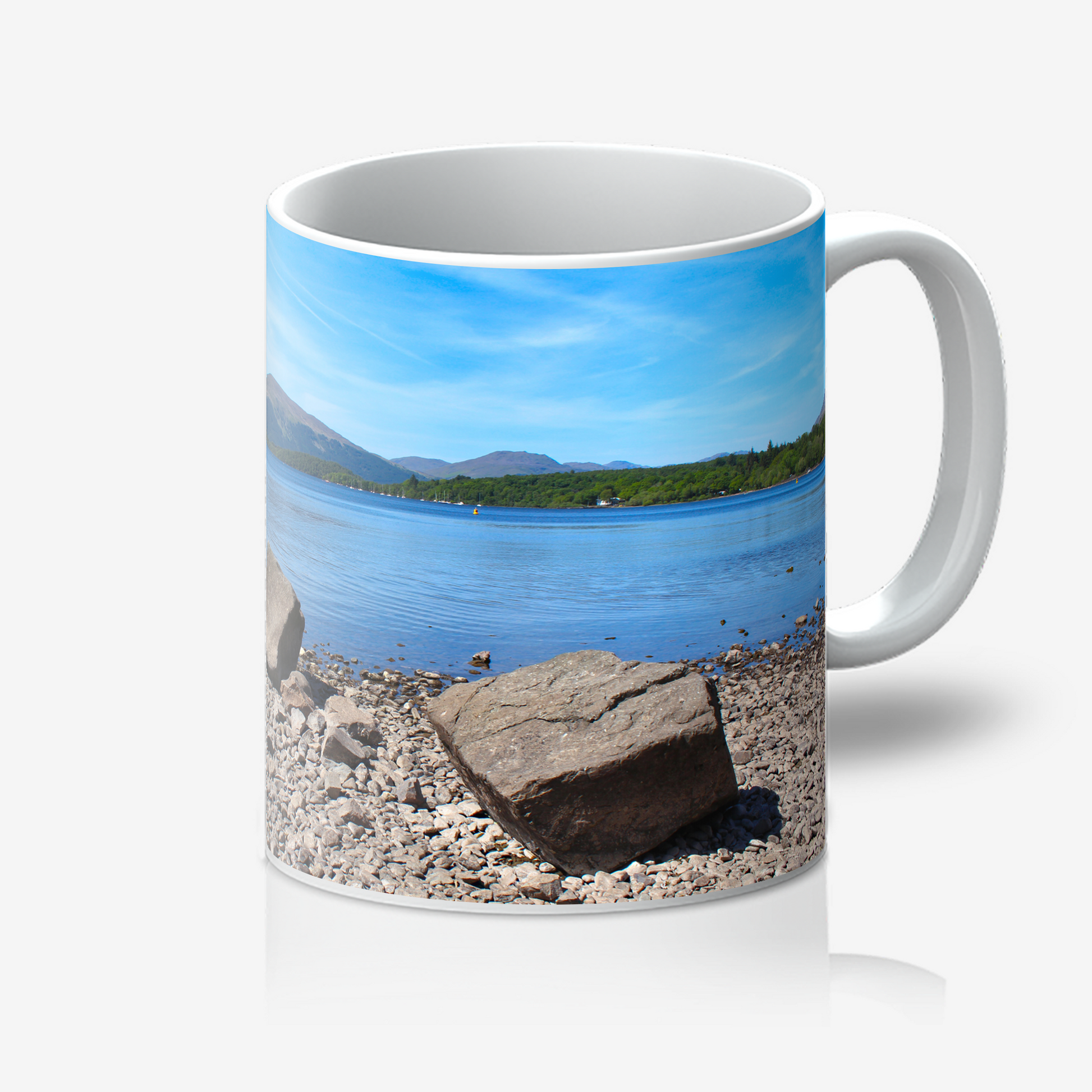 Mug with a scenic design of a lake and mountains on a white background