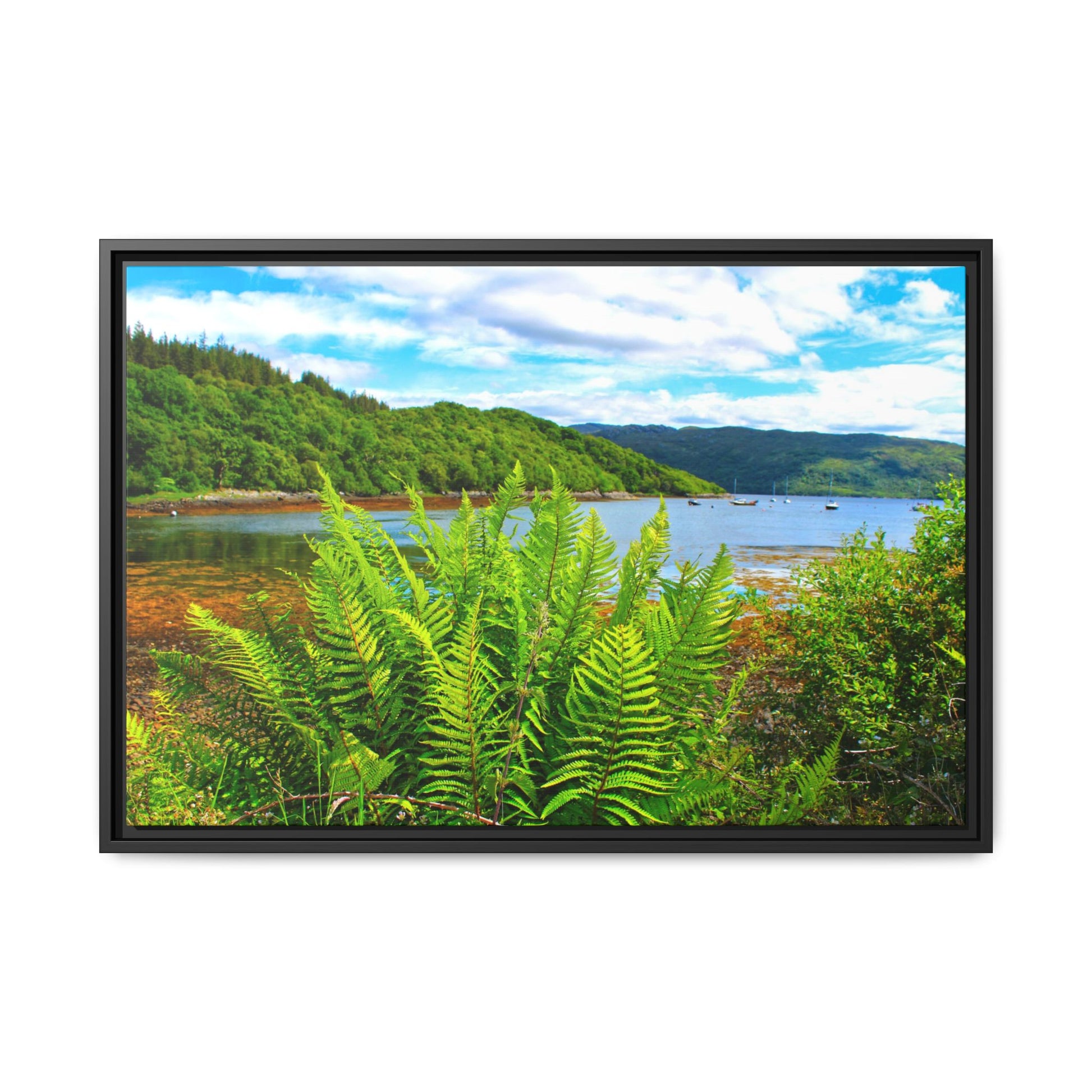 Framed picture of a scenic landscape with greenery and water.
