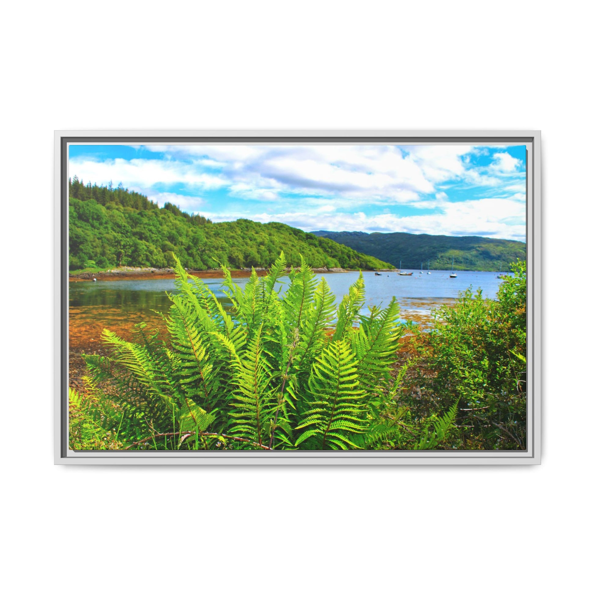 Framed picture of a scenic landscape with a lake and mountains.