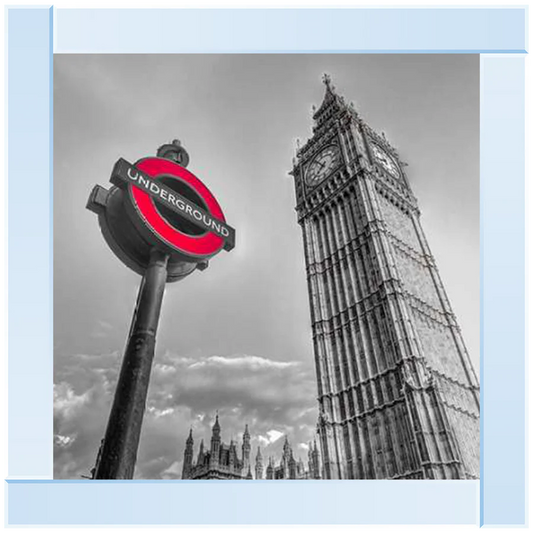 A silver mirror framed picture featuring the London Big Ben clock tower and an underground sign.