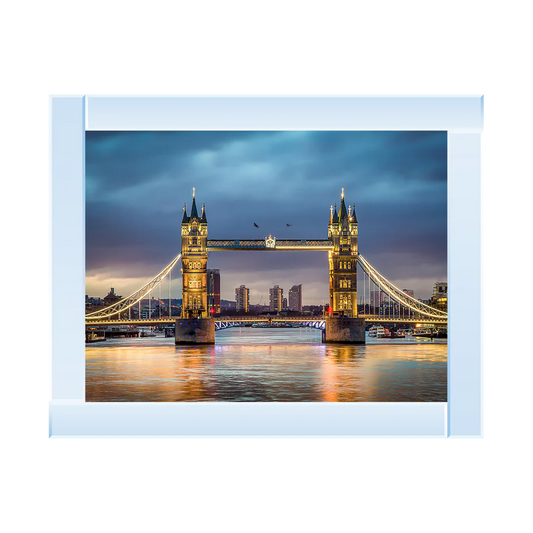 Framed picture of Tower Bridge in London at dusk with a silver mirror frame.