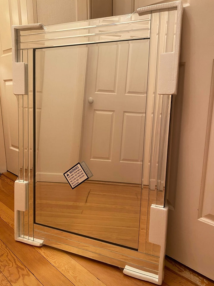 Silver bevelled edge wall mirror.