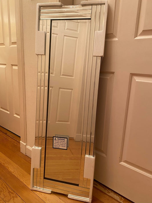 Long silver bevelled edge wall mirror.
