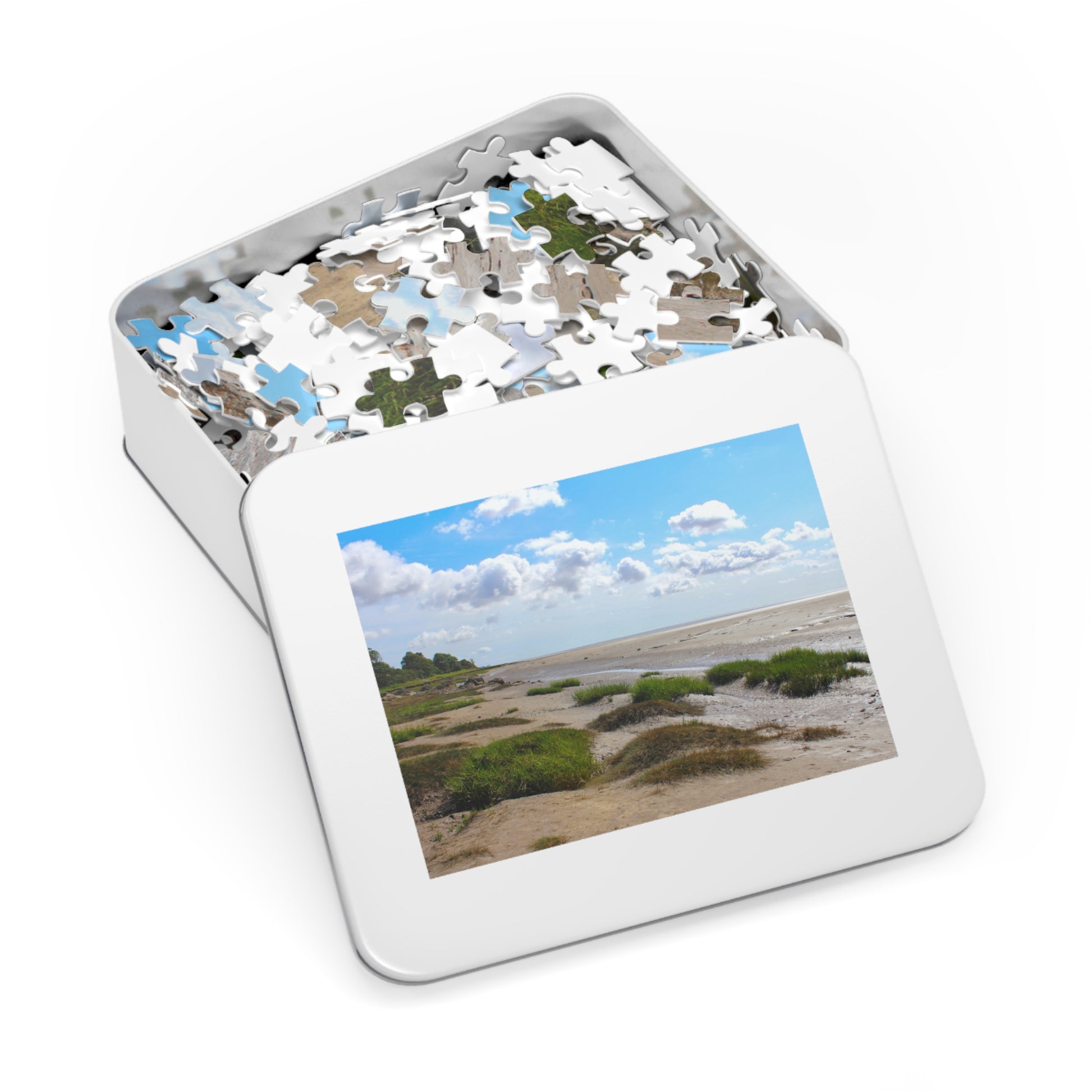 Jigsaw puzzle in a tin with a scenic image on a white background
