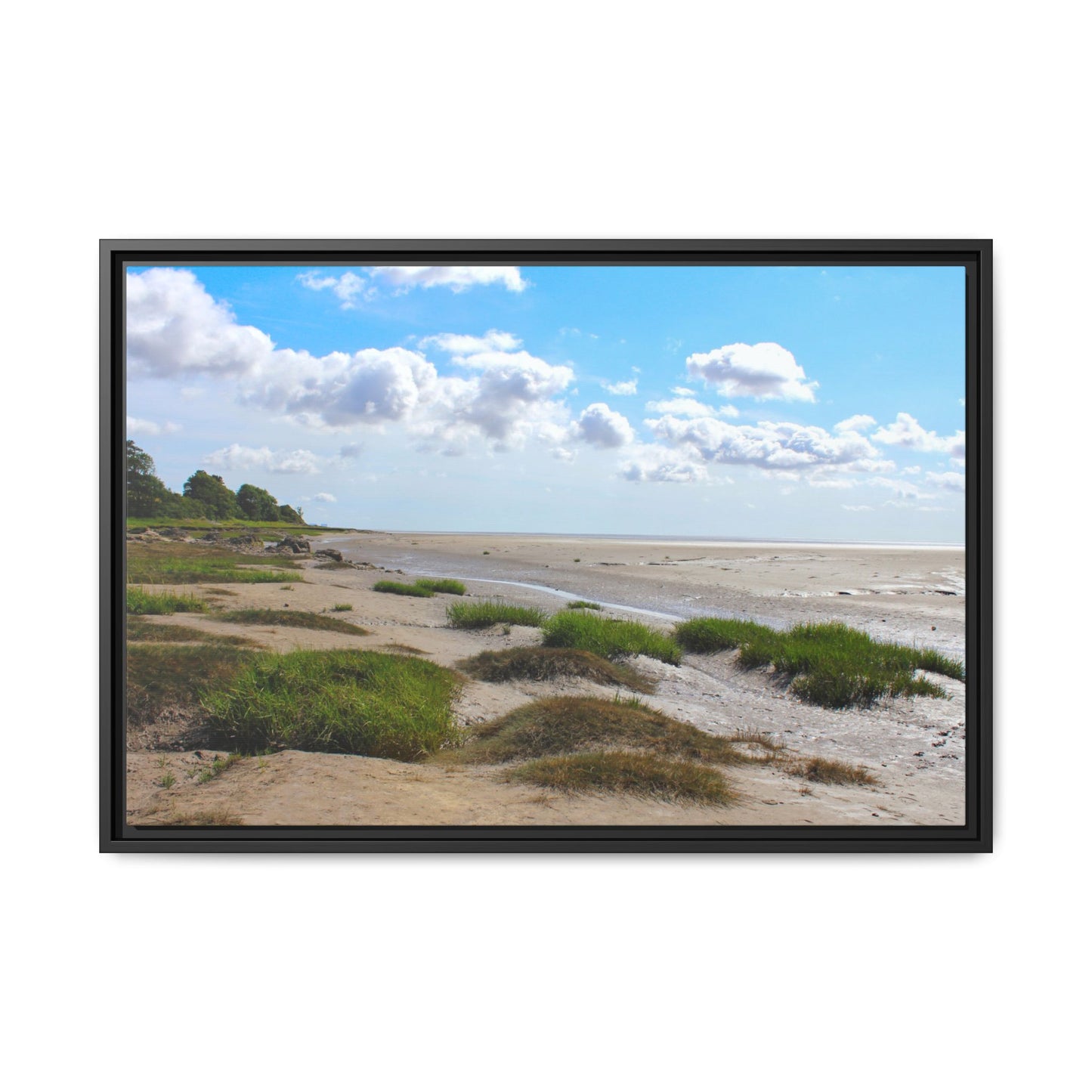 Framed picture of a beach scene with grassy dunes and a blue sky.