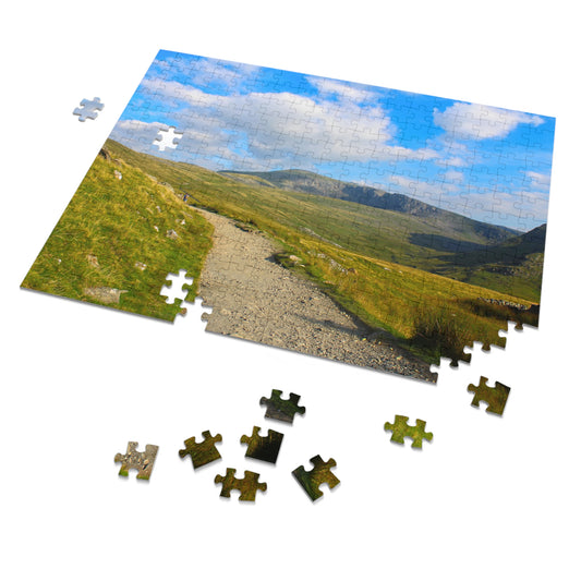 Jigsaw puzzle with a scenic landscape of a path and mountains on a white background