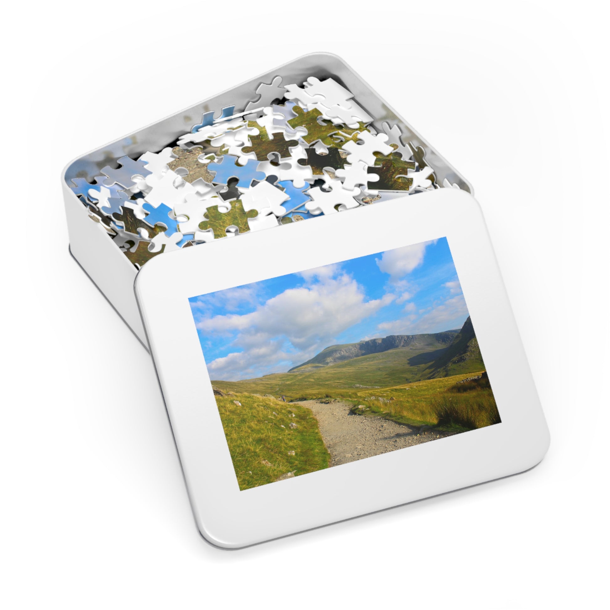 Jigsaw puzzle with a scenic view of a mountain landscape on a white background