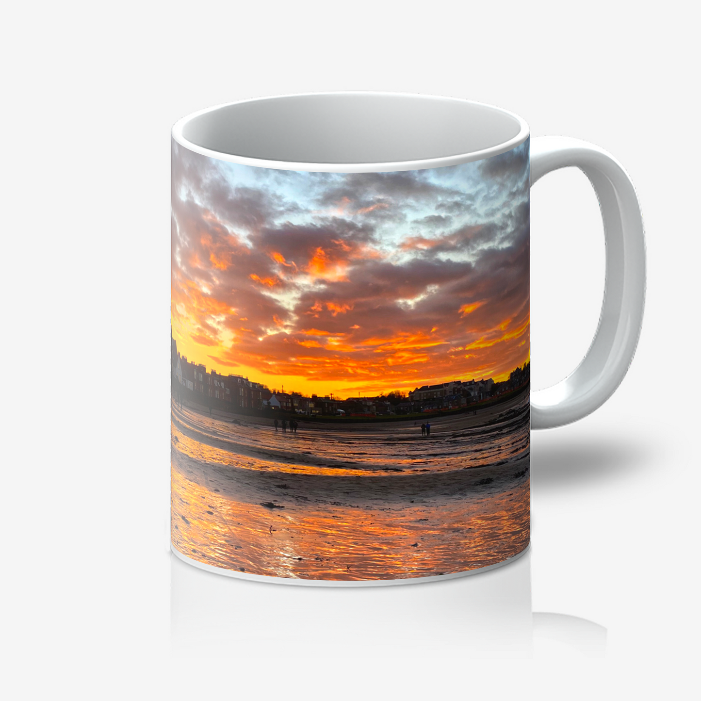 Mug with a sunset over water design on a white background