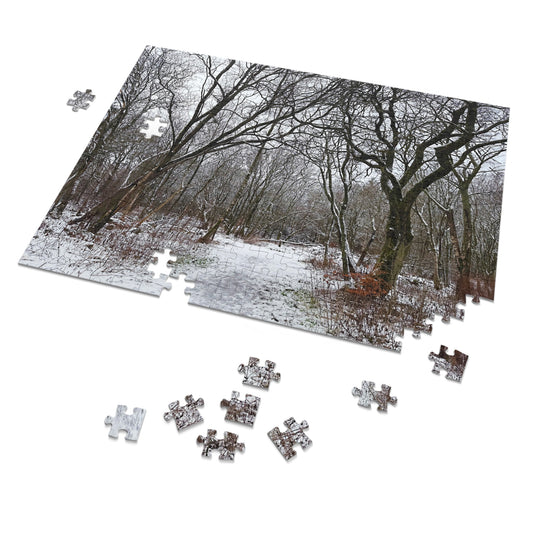 Jigsaw puzzle of a snowy forest with completed pieces on a white background