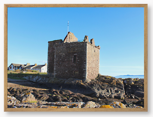 Framed Photo of a Stone castle on rocky terrain with a clear blue sky