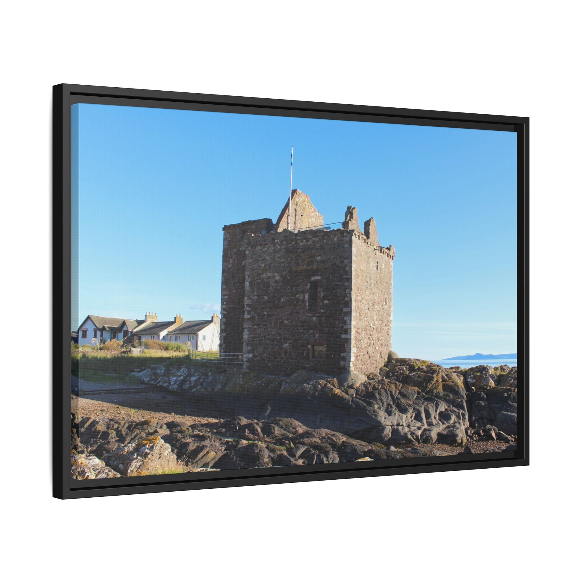 Framed picture of a stone tower with a blue sky background