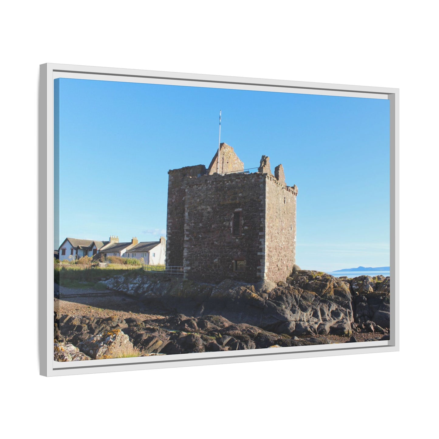 Framed picture of a stone tower with a clear blue sky