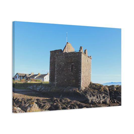 Stone tower on a rocky outcrop with clear blue sky