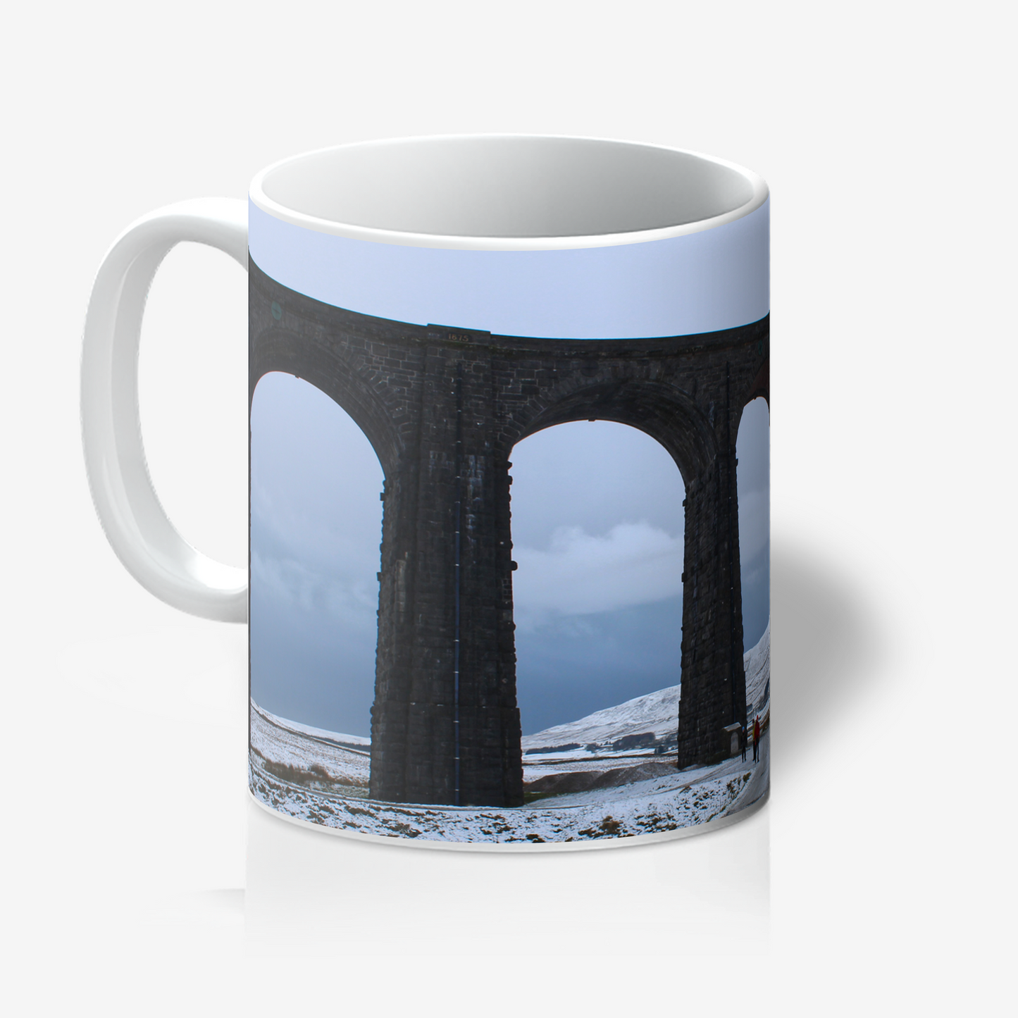 Mug with a design of a viaduct and snowy landscape on a white background