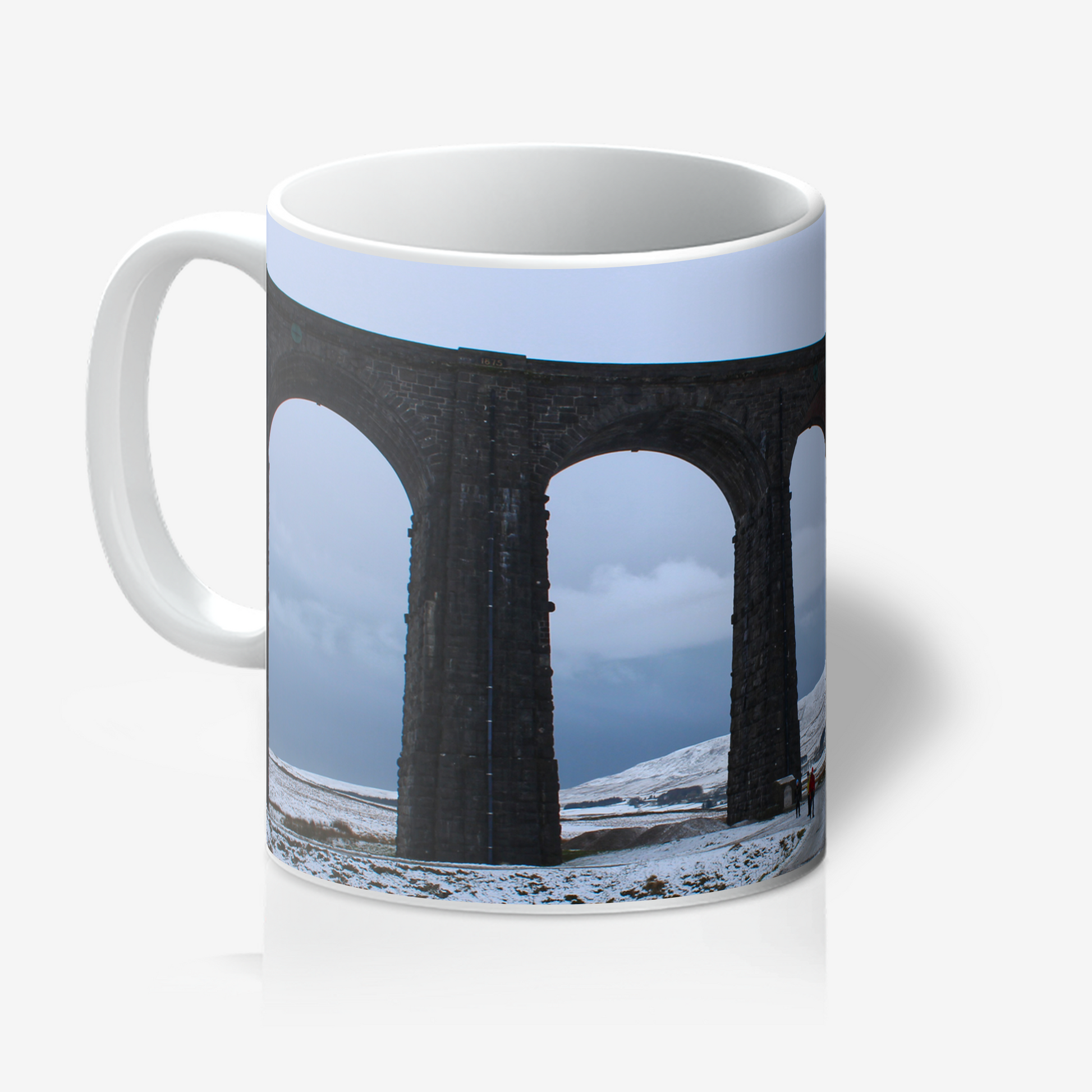 Mug with a design of a viaduct and snowy landscape on a white background