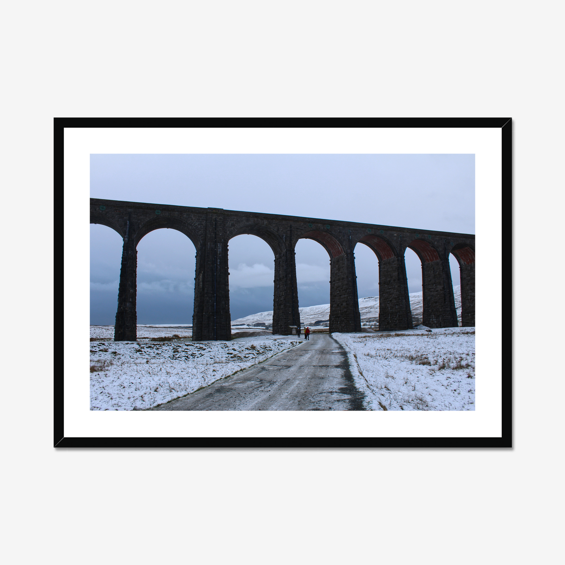 Framed photograph featuring the Ribblehead Viaduct in winter with snow on the ground and a cloudy sky.