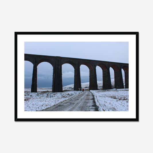 Framed photograph featuring the Ribblehead Viaduct in winter with snow on the ground and a cloudy sky.