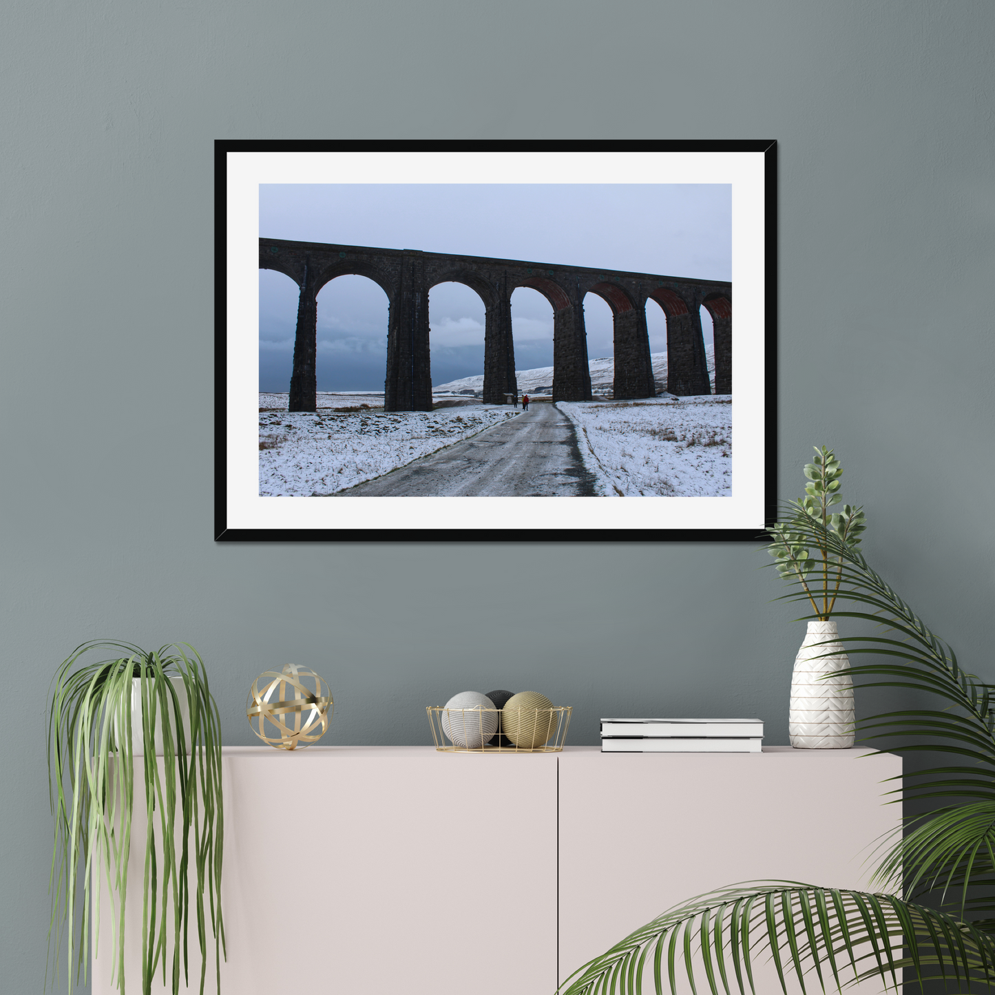 Framed photograph featuring the Ribblehead Viaduct in winter with snow on the ground and a cloudy sky.