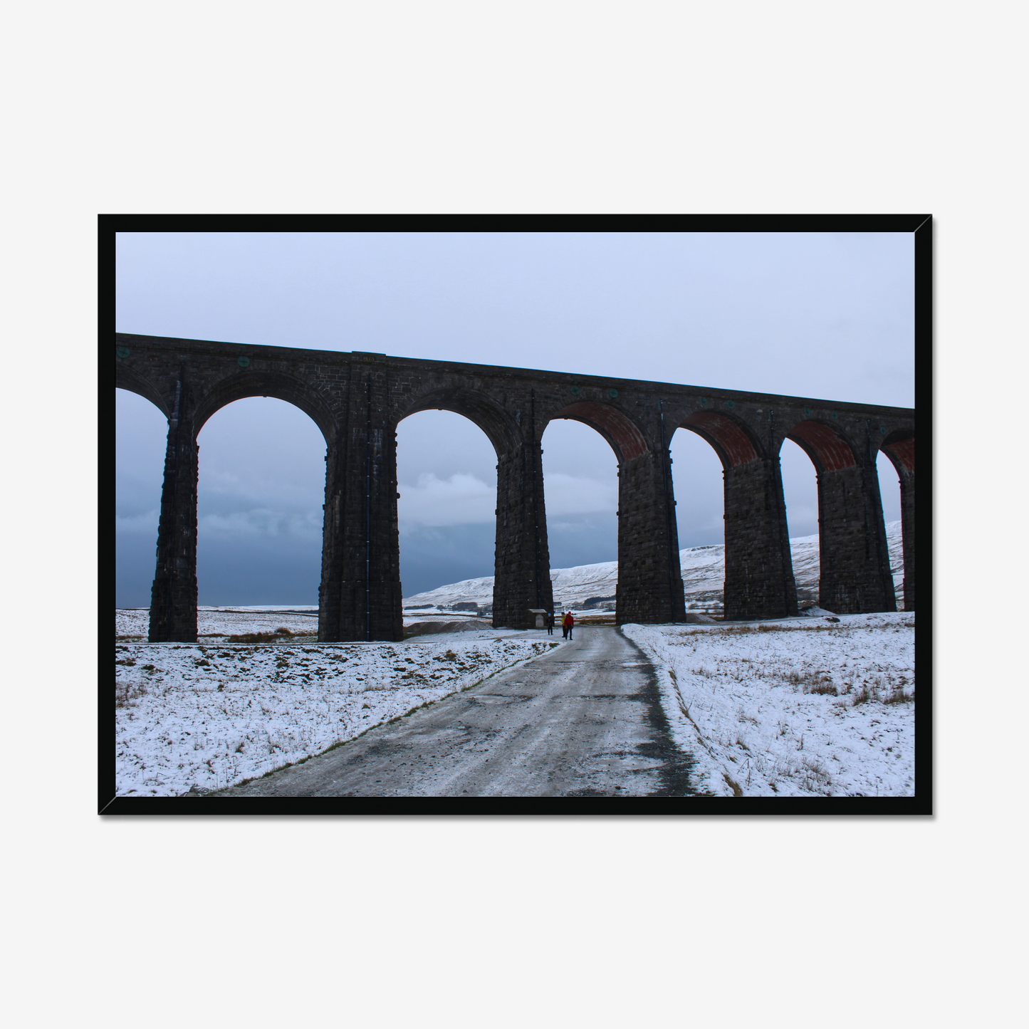 Framed photograph featuring the Ribblehead Viaduct in winter with snow on the ground and a cloudy sky.