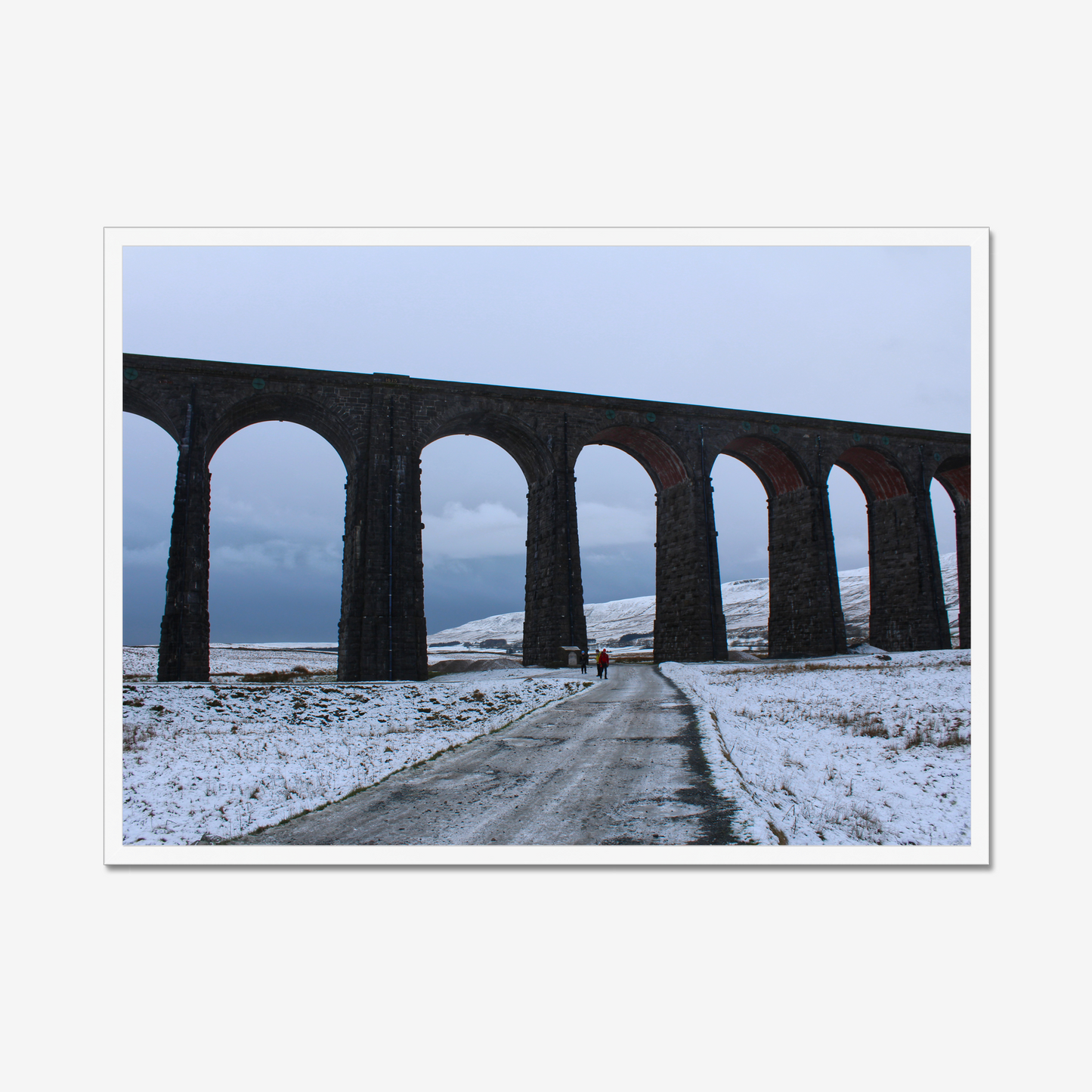 Framed photograph featuring the Ribblehead Viaduct in winter with snow on the ground and a cloudy sky.