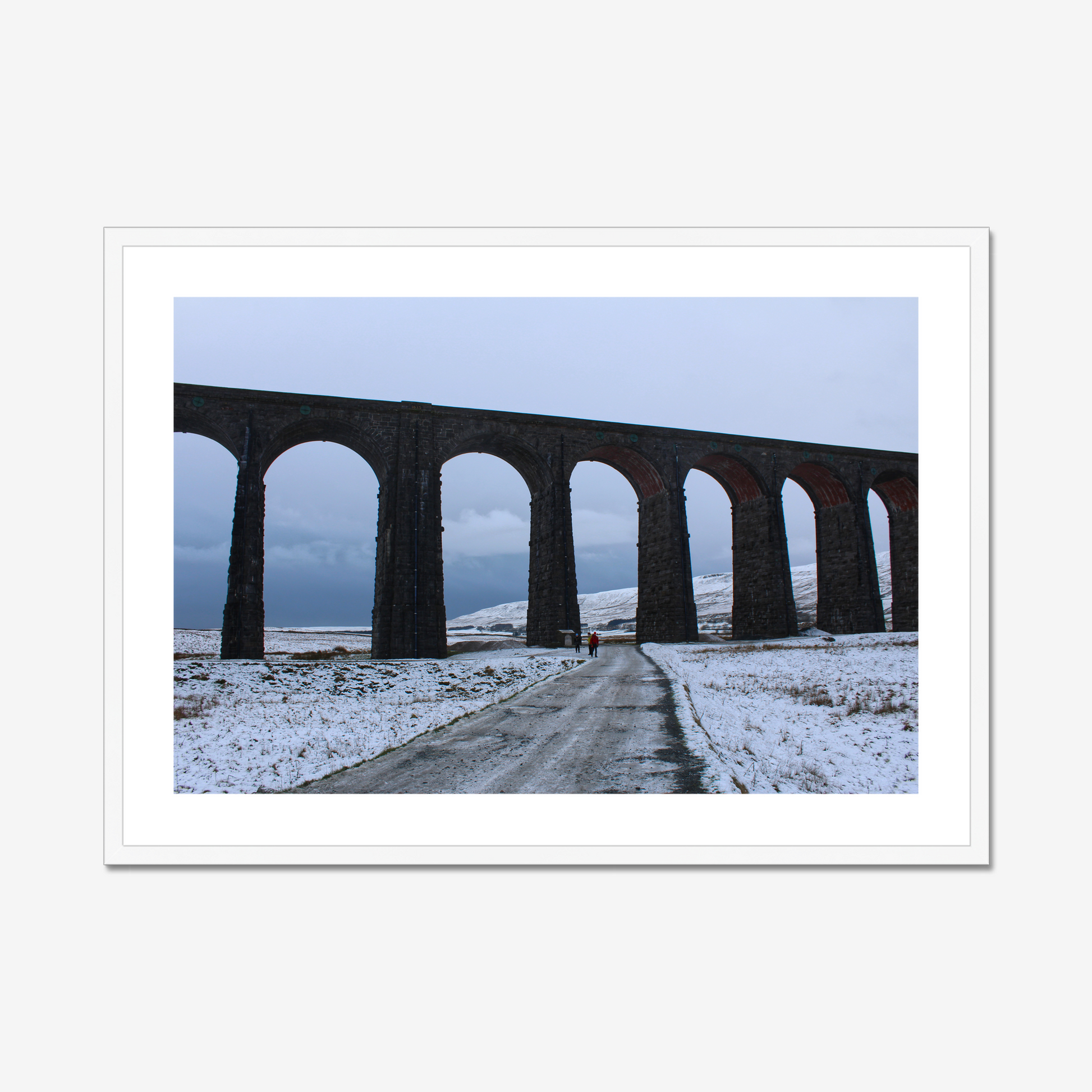 Framed photograph featuring the Ribblehead Viaduct in winter with snow on the ground and a cloudy sky.