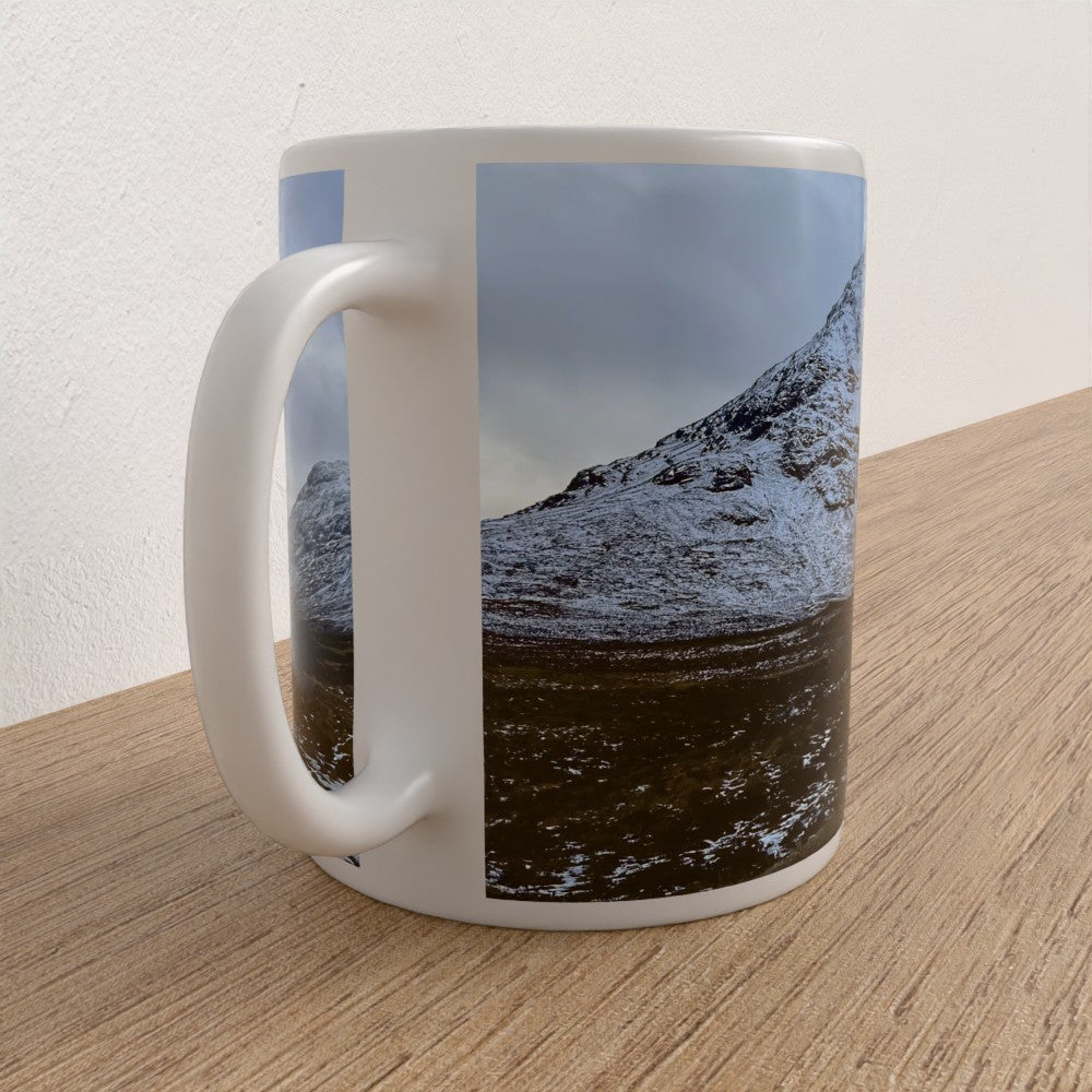 Mug with a mountain landscape design on a wooden surface