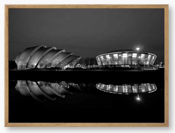 Black and White Framed Photo featuring the Glasgow SEC Armadillo and Hydro buildings lit up at night, reflected in the water of the Clyde.