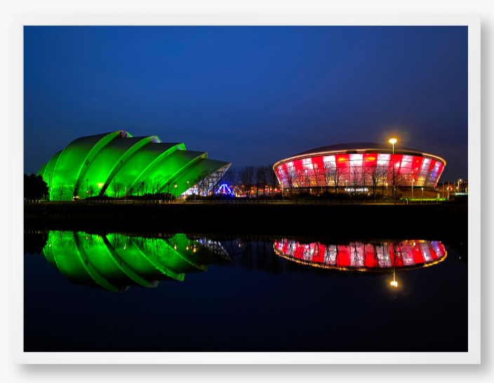 Framed Photo featuring the Glasgow SEC Armadillo and Hydro buildings lit up at night, reflected in the water of the Clyde.