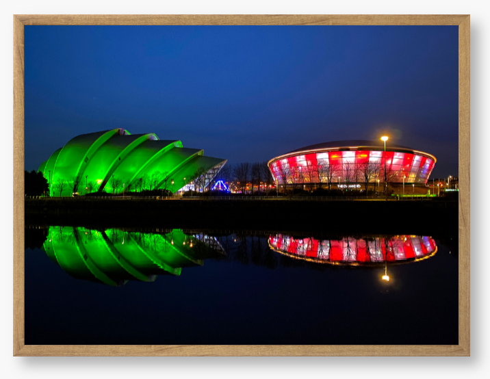 Framed Photo featuring the Glasgow SEC Armadillo and Hydro buildings lit up at night, reflected in the water of the Clyde.