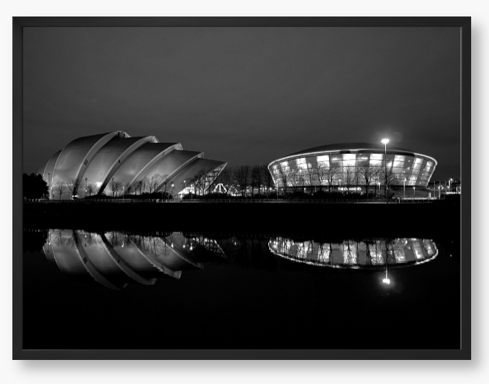 Black and White Framed Photo featuring the Glasgow SEC Armadillo and Hydro buildings lit up at night, reflected in the water of the Clyde.