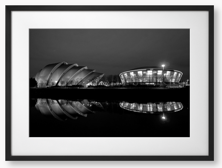 Black and White Framed Photo featuring the Glasgow SEC Armadillo and Hydro buildings lit up at night, reflected in the water of the Clyde.