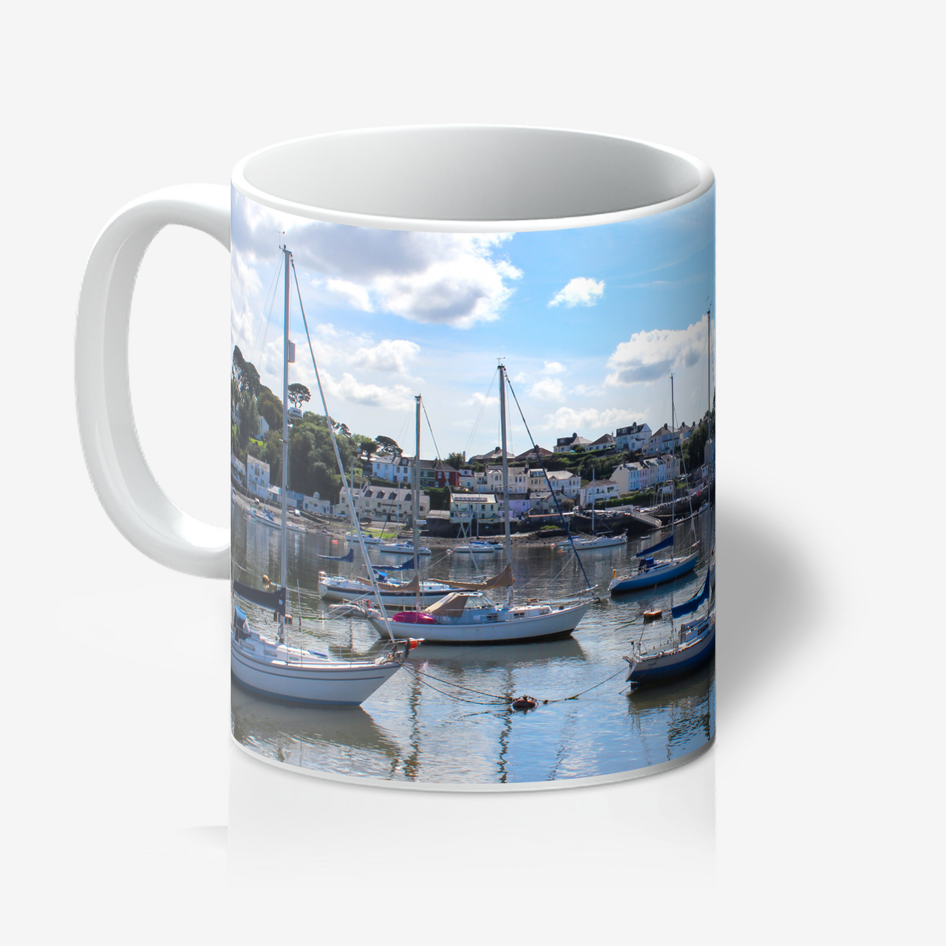 Mug with a scenic design of boats and buildings on a white background